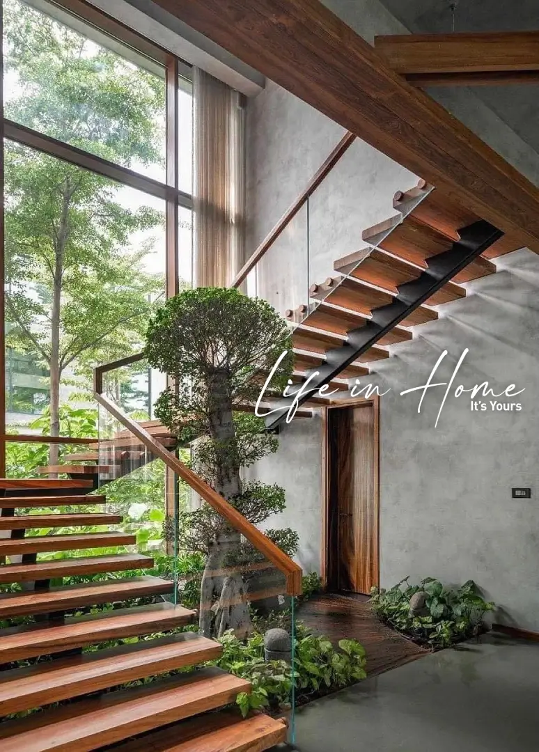 Luxury modern floating staircase with solid teak wood treads and frameless glass railing for a high-end farmhouse in Coimbatore.